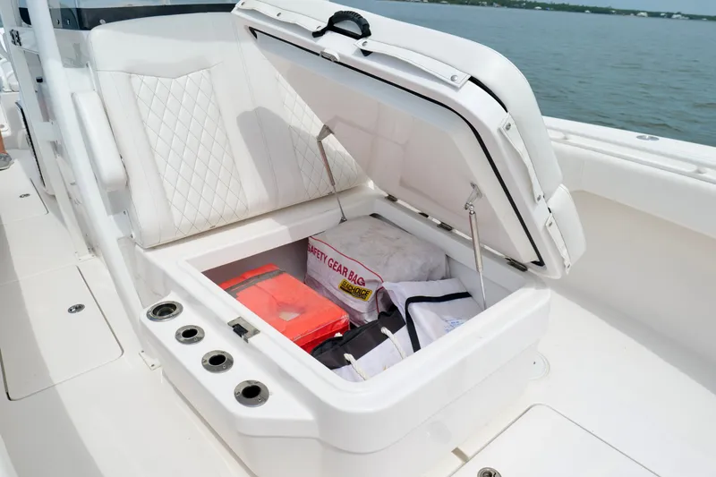 Slide: The Image of Storage compartment on 2025 Fountain 34 Tournament Edition boat with safety gear and accessories. - 35