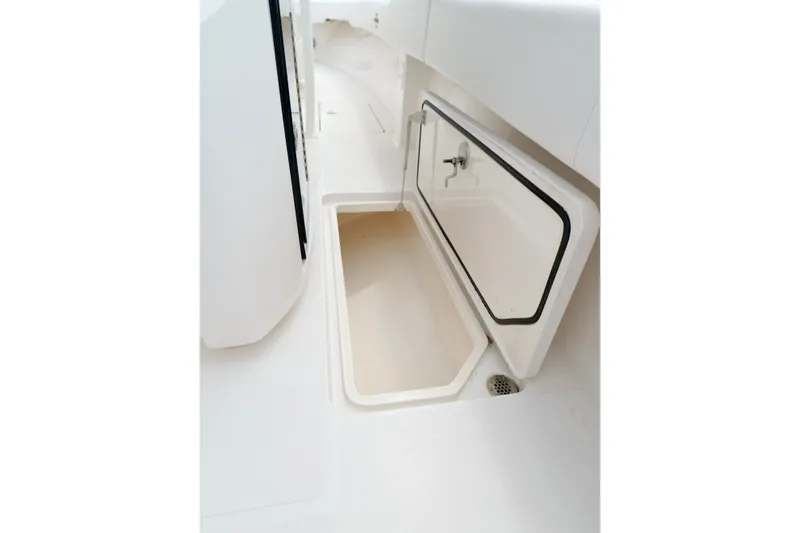 Slide: The Image of Open storage compartment on 2025 Fountain 34 Tournament Edition boat deck. - 38