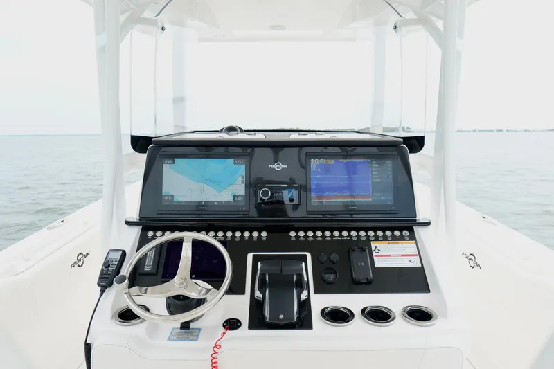 Slide: The Image of 2025 Fountain 34 Tournament Edition boat dashboard with advanced navigation displays. - 13