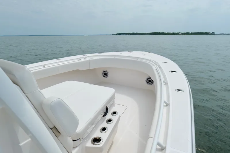Slide: The Image of 2025 Fountain 34 Tournament Edition boat on calm waters, showcasing sleek design and seating. - 32