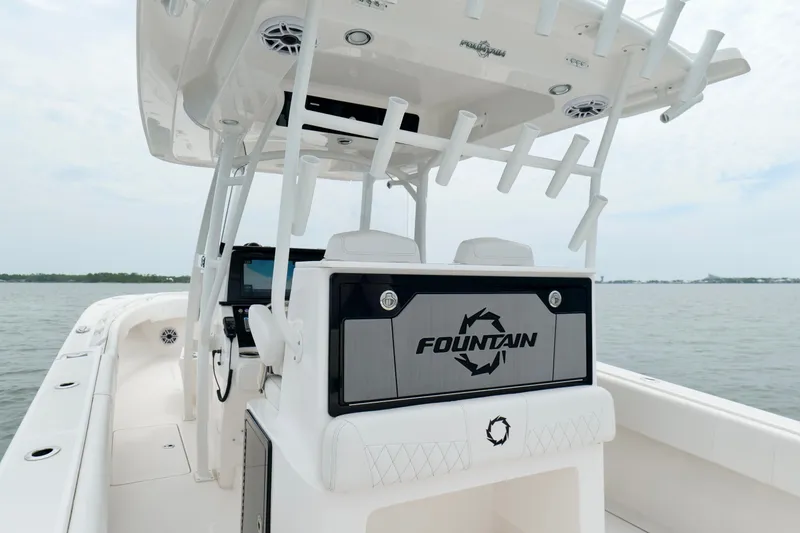 Slide: The Image of 2025 Fountain 34 Tournament Edition boat interior with rod holders and steering console. - 23