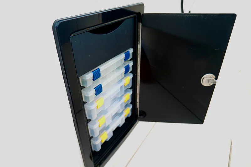 Slide: The Image of Storage compartment with organized tackle boxes on the 2025 Fountain 34 Tournament Edition boat. - 28