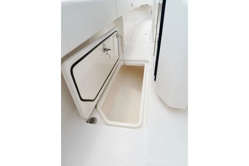 Slide: The Image of Open storage compartment on 2025 Fountain 34 Tournament Edition boat deck. - 37