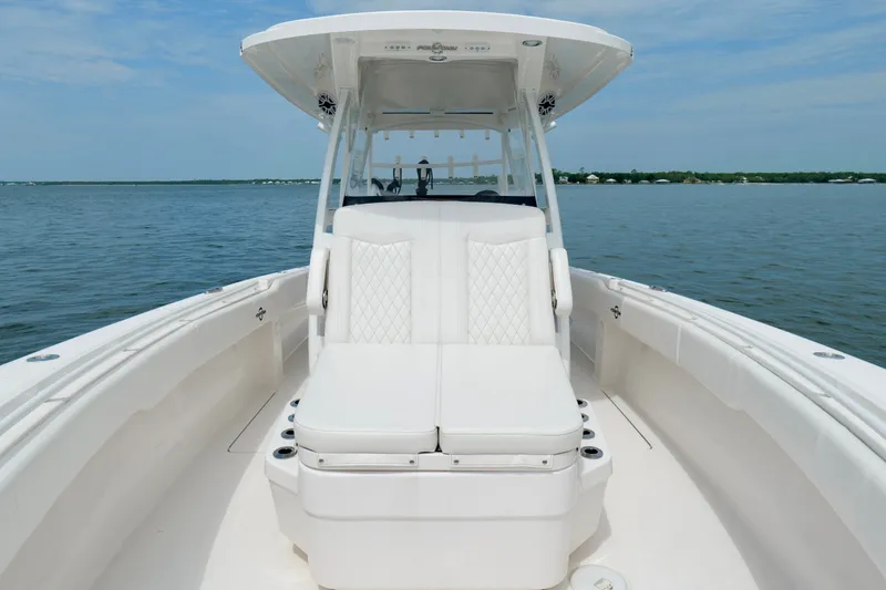 Slide: The Image of 2025 Fountain 34 Tournament Edition boat on calm water, featuring sleek white seating. - 34