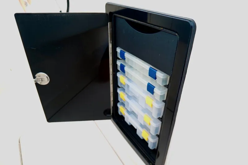 Slide: The Image of Storage compartment with organized tackle boxes on a 2025 Fountain 34 Tournament Edition boat. - 27