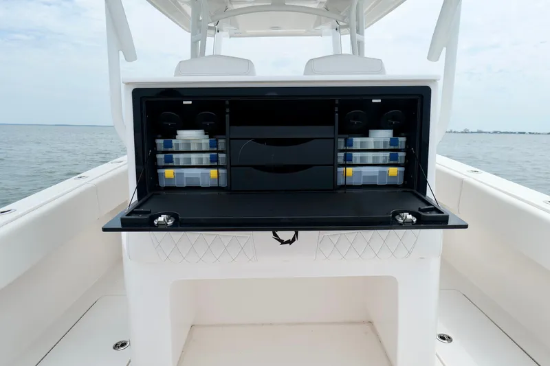 Slide: The Image of 2025 Fountain 34 Tournament Edition boat with open storage compartment, organized tackle boxes. - 24