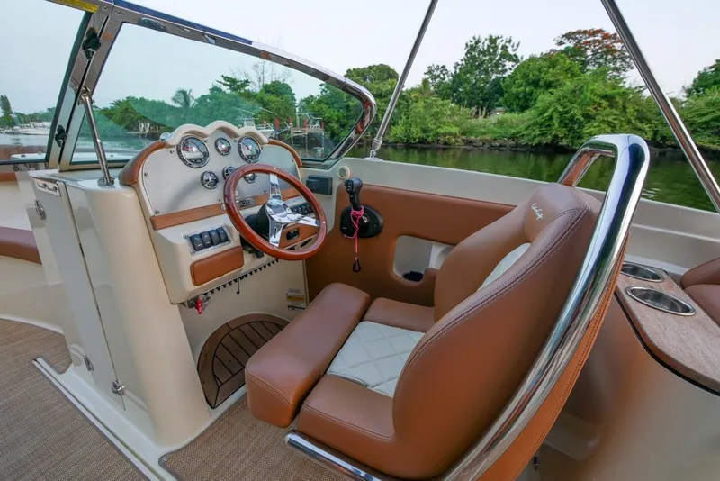Slide: The Image of 2018 Chris-Craft Launch 27 boat interior with elegant dashboard and leather seating. - 21