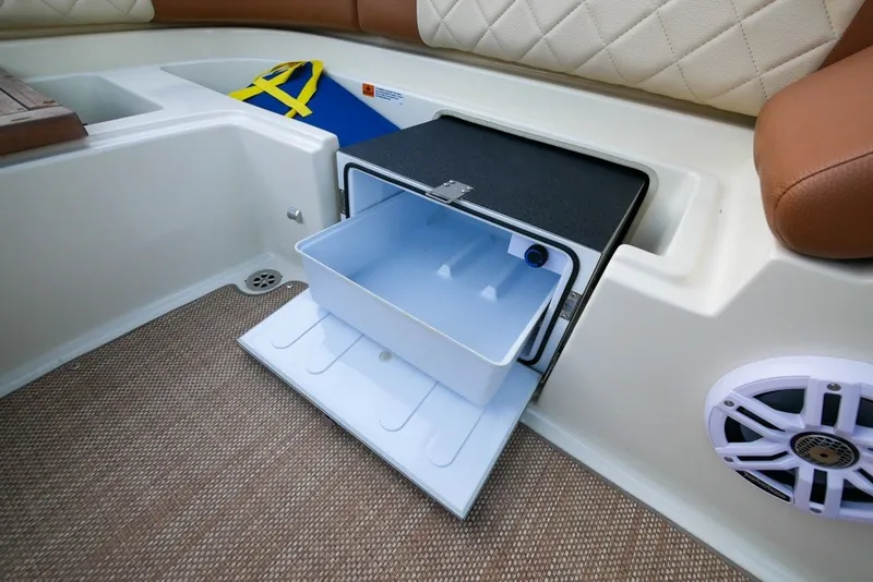 Slide: The Image of 2018 Chris-Craft Launch 27 interior with open storage compartment and speaker. - 14