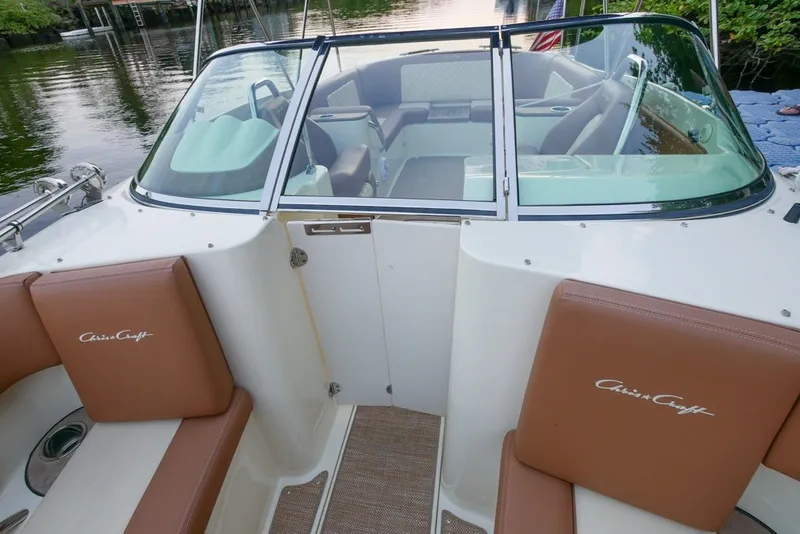 Slide: The Image of 2018 Chris-Craft Launch 27 boat interior with brown seating and windshield. - 25