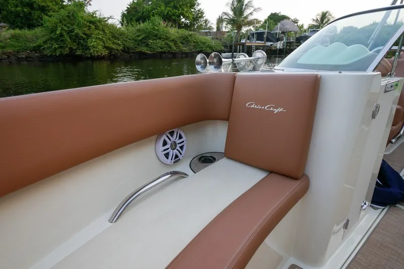 Slide: The Image of 2018 Chris-Craft Launch 27 boat interior with brown leather seating and speaker detail. - 27