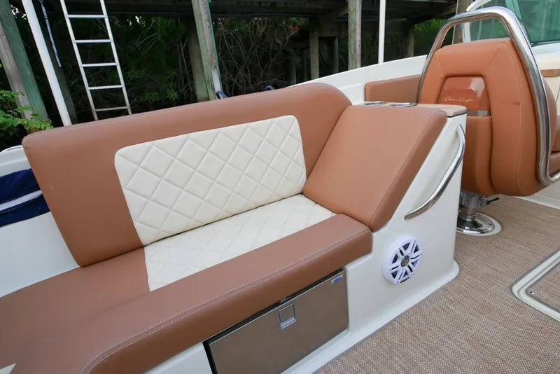 Slide: The Image of 2018 Chris-Craft Launch 27 interior with tan and white seating, stainless steel accents. - 13