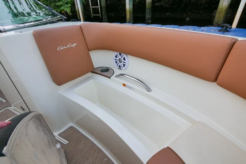 Slide: The Image of 2018 Chris-Craft Launch 27 boat interior with tan seating and built-in speaker. - 31
