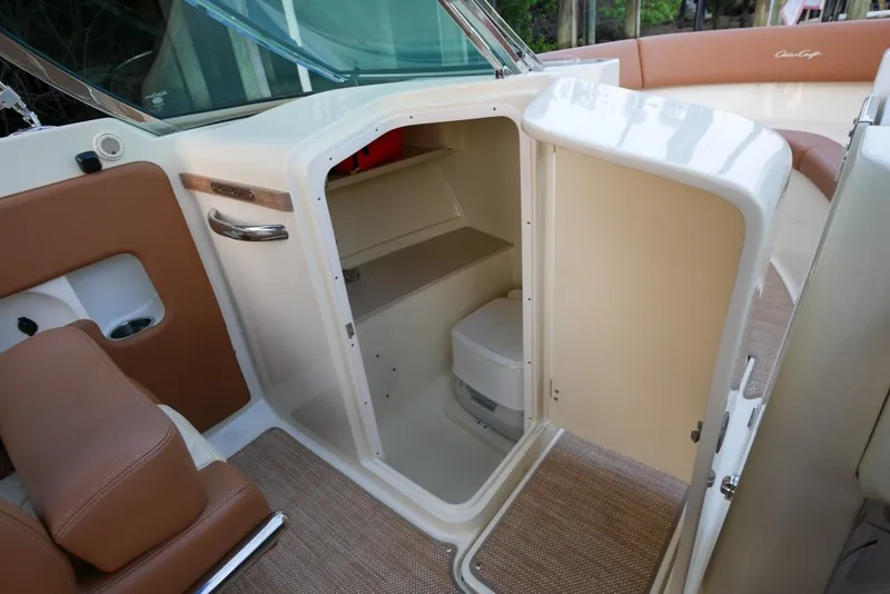 Slide: The Image of 2018 Chris-Craft Launch 27 interior showing cabin storage and seating area. - 19