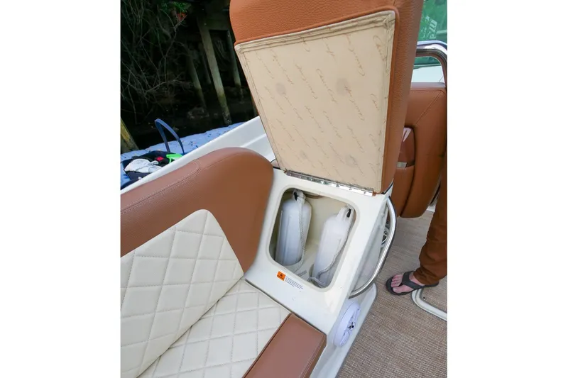 Slide: The Image of 2018 Chris-Craft Launch 27 boat seat storage compartment with life jackets visible. - 28