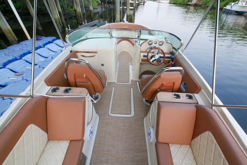 Slide: The Image of 2018 Chris-Craft Launch 27 boat interior with tan leather seats and elegant dashboard. - 16