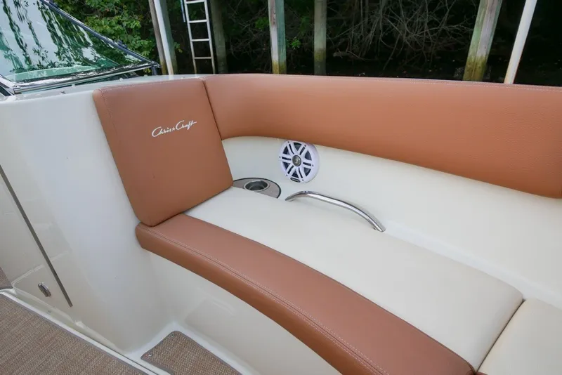 Slide: The Image of 2018 Chris-Craft Launch 27 boat interior with tan leather seating and speaker. - 30