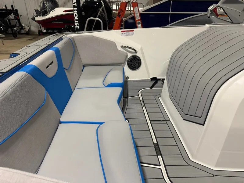 Slide: The Image of The image shows the interior of a 2025 Nautique Ski Nautique 200 Open Bow with gray and blue seating. - 21