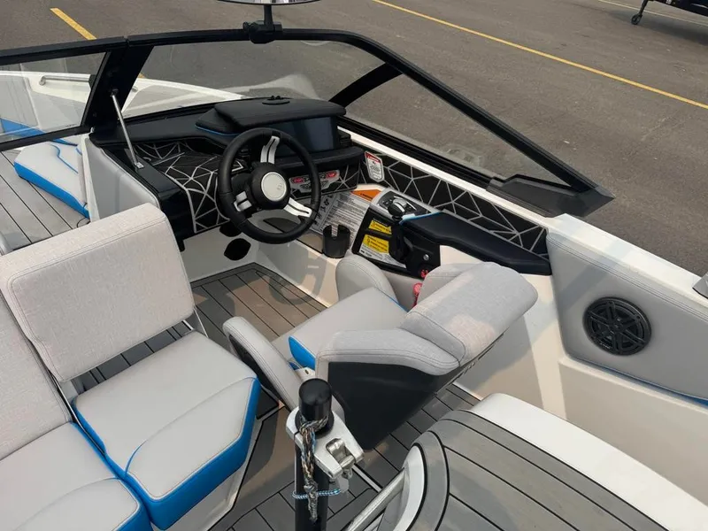 Slide: The Image of The image shows the cockpit of a 2025 Nautique Ski Nautique 200 Open Bow with modern seating and controls. - 17