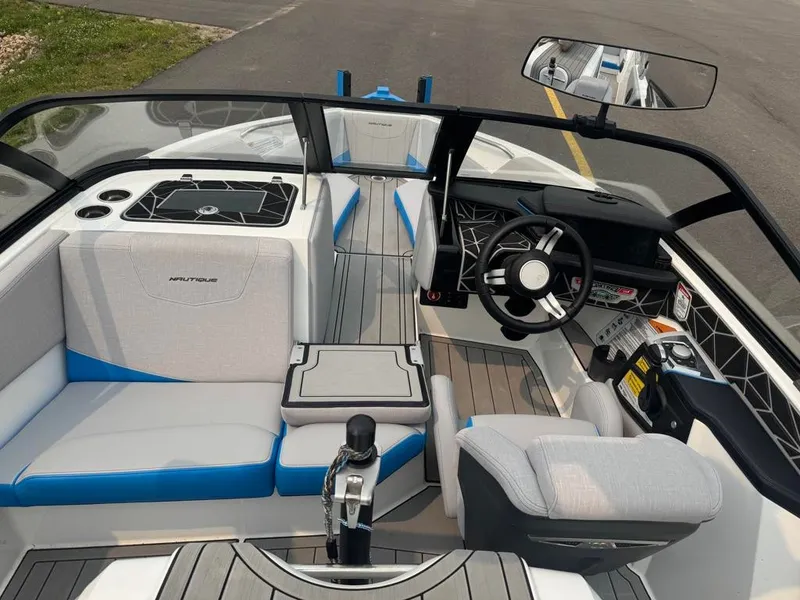 Slide: The Image of The image shows the cockpit of a 2025 Nautique Ski Nautique 200 Open Bow with modern seating and controls. - 14