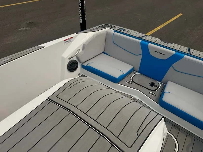 Slide: The Image of The image shows the interior of a 2025 Nautique Ski Nautique 200 Open Bow with gray and blue upholstery. - 25
