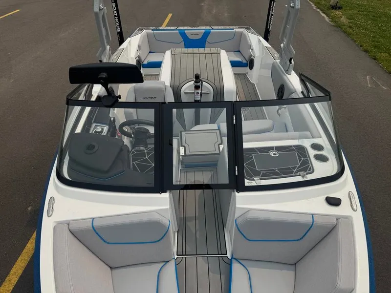 Slide: The Image of The image shows the cockpit of a 2025 Nautique Ski Nautique 200 Open Bow with modern seating and controls. - 12