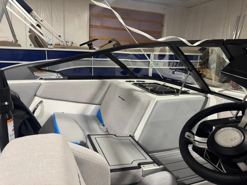 Slide: The Image of Interior view of a modern boat with gray seating and a black steering wheel. - 18