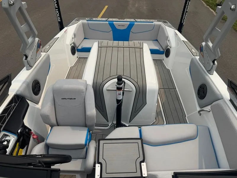 Slide: The Image of The image shows the interior of a 2025 Nautique Ski Nautique 200 Open Bow with gray and blue seating. - 15