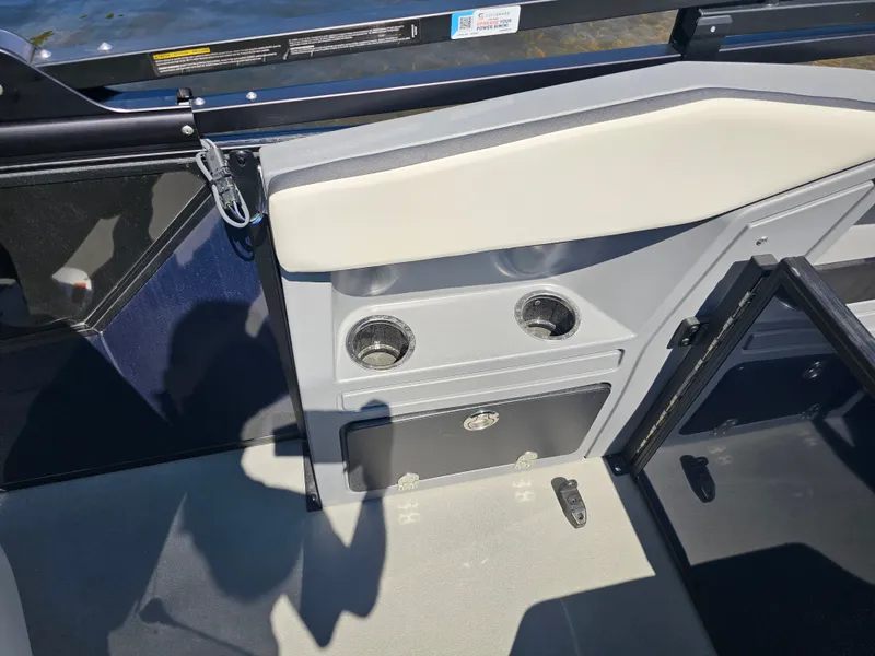 Slide: The Image of The image shows the interior of a Sylvan R-20 CLZ DH boat with cup holders. - 9