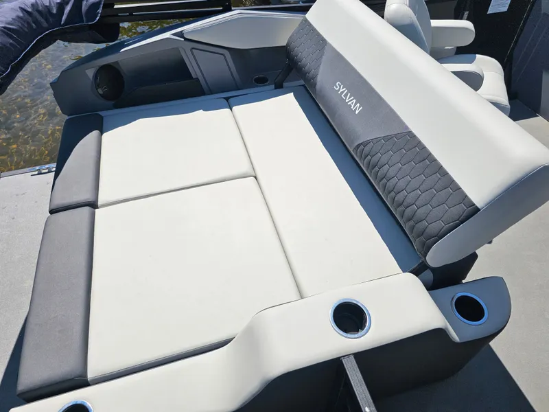 Slide: The Image of The image shows a luxurious lounging area on a Sylvan boat, with cushioned seats and cup holders. - 10