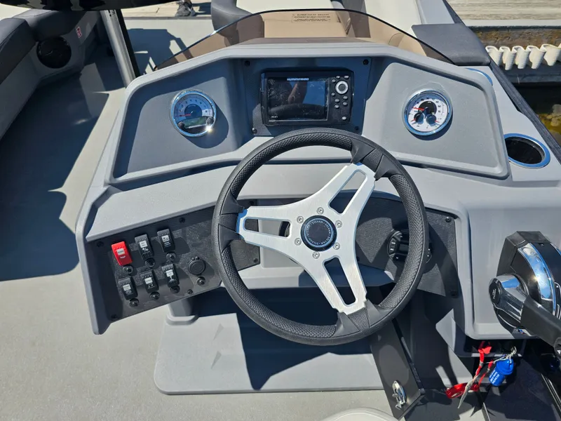 Slide: The Image of The image shows the helm of a 2026 Sylvan R-20 CLZ DH boat with a steering wheel and instruments. - 5