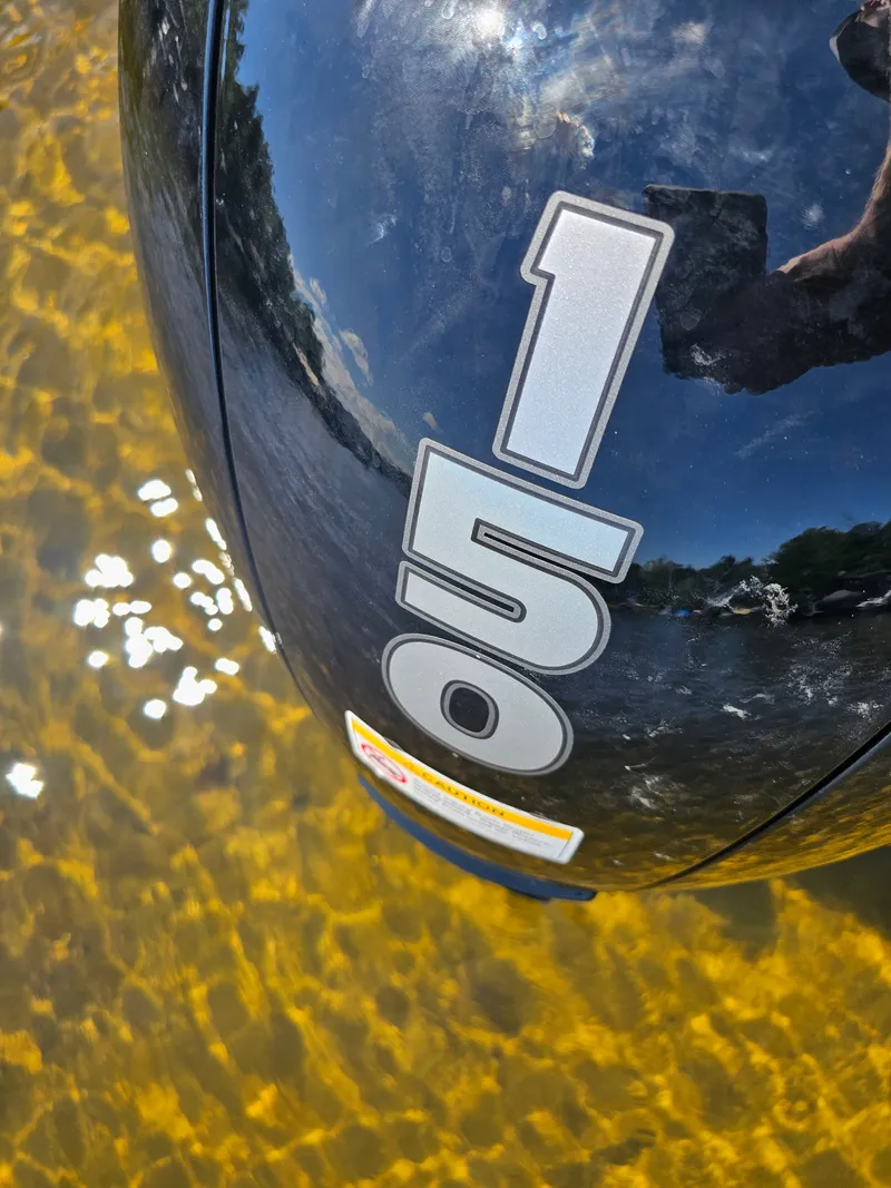 Slide: The Image of Close-up of an outboard motor labeled "150" in clear water. - 11