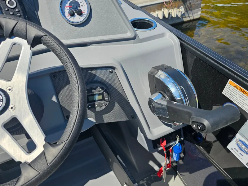 Slide: The Image of Close-up of the helm of a Sylvan R-20 CLZ DH boat with steering wheel and throttle. - 8