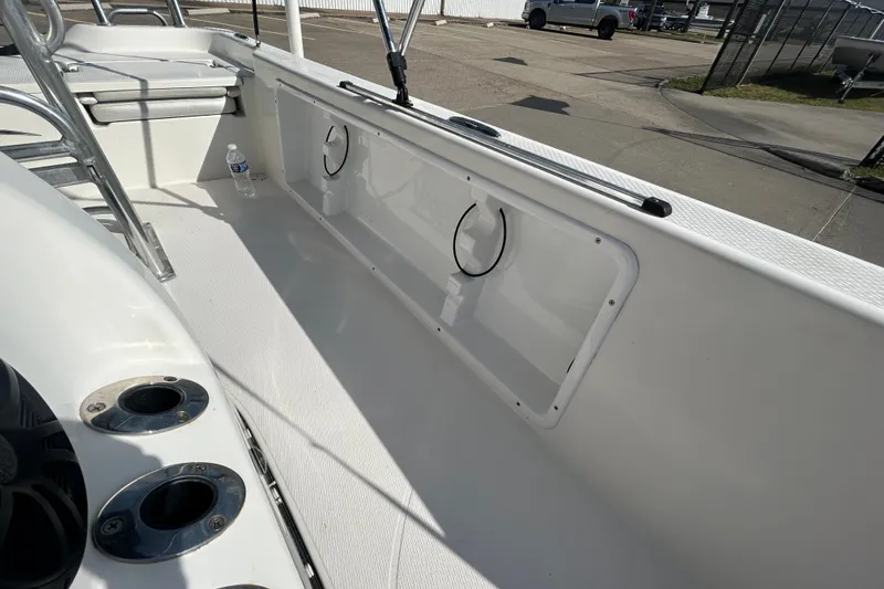 Slide: The Image of 2016 Blue Wave 2000 PureBay boat interior with rod holders and storage compartments. - 13