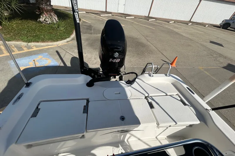 Slide: The Image of 2016 Blue Wave 2000 PureBay boat with Suzuki 140 engine in parking lot. - 12