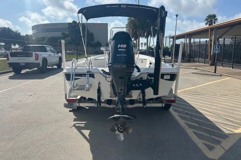 Slide: The Image of 2016 Blue Wave 2000 PureBay boat with outboard motor in parking lot. - 5