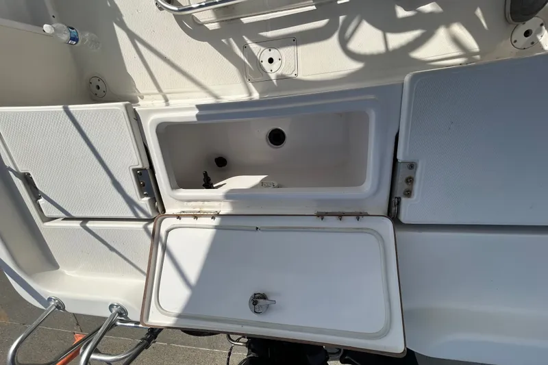 Slide: The Image of Open storage compartment on a 2016 Blue Wave 2000 PureBay boat deck. - 7