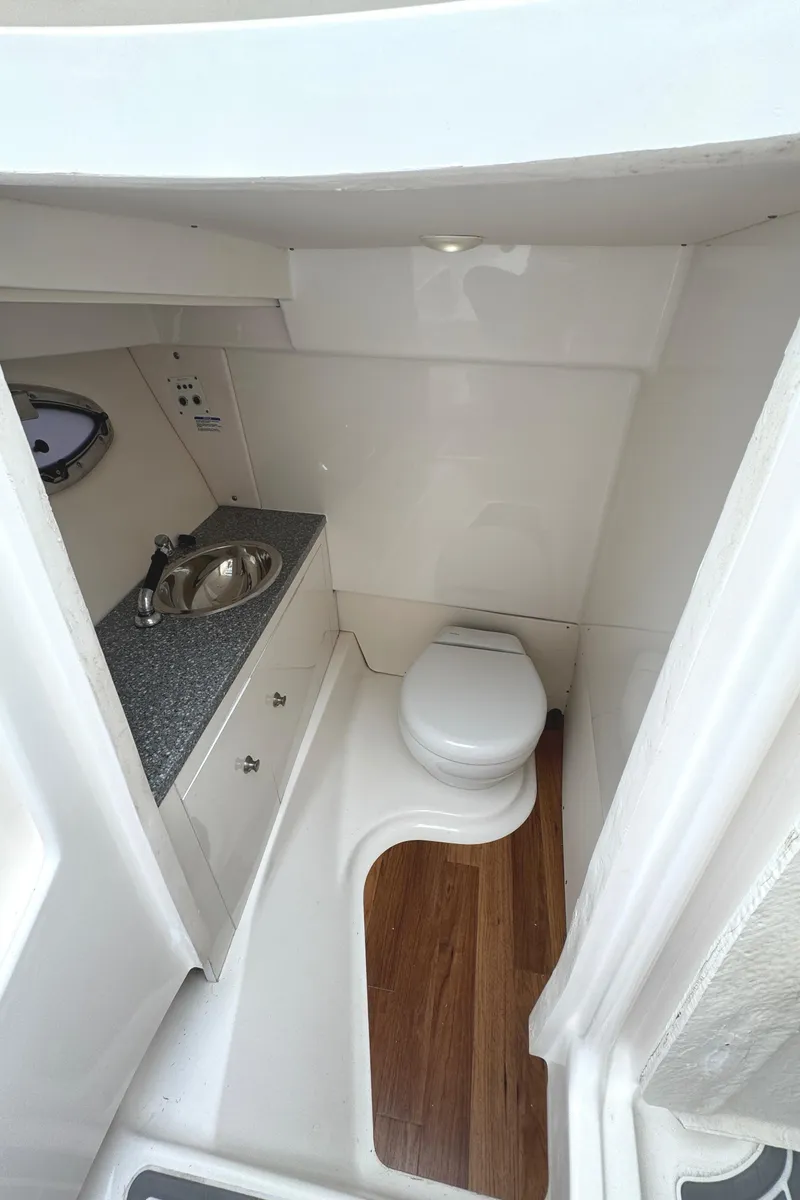 Slide: The Image of 2018 Robalo R317 Dual Console boat bathroom with sink and toilet. - 13