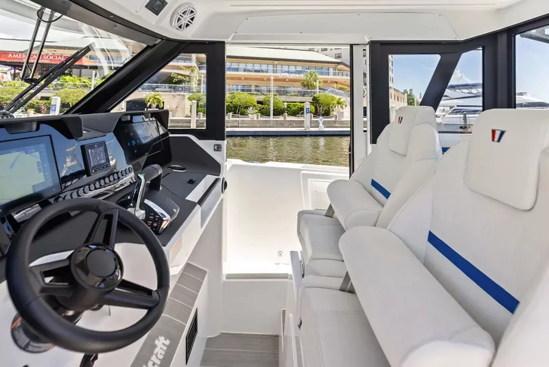 Slide: The Image of The image shows the cockpit of a 2027 Wellcraft 28 Explorer with modern instruments and comfortable seating. - 20