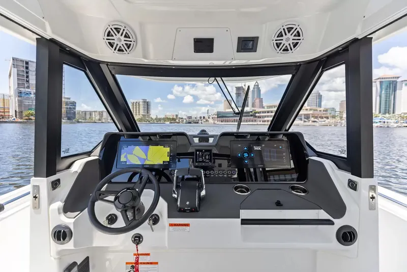Slide: The Image of The cockpit of the 2027 Wellcraft 28 Explorer features modern navigation systems and a sleek design. - 15