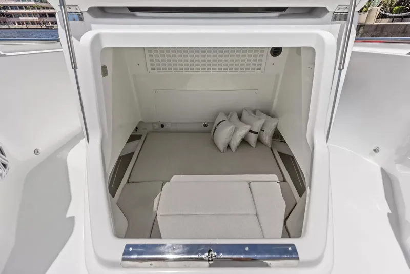 Slide: The Image of The interior of a 2027 Wellcraft 28 Explorer features a clean, cushioned cabin with pillows. - 24