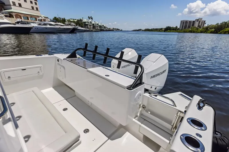 Slide: The Image of The image shows a modern boat with twin Mercury outboard engines docked in a calm harbor. - 7