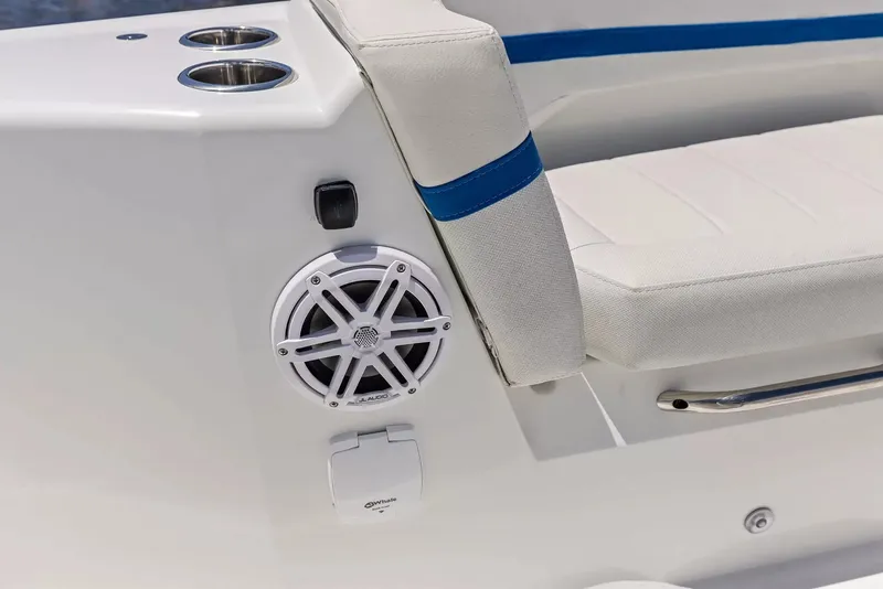 Slide: The Image of Close-up of a white seat with blue trim and speaker on a Wellcraft 28 Explorer boat. - 30