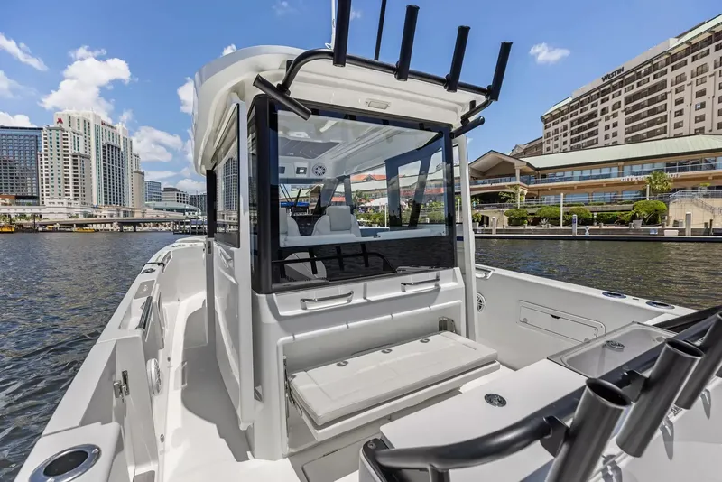 Slide: The Image of The image shows a modern Wellcraft 28 Explorer boat docked, surrounded by urban buildings. - 11