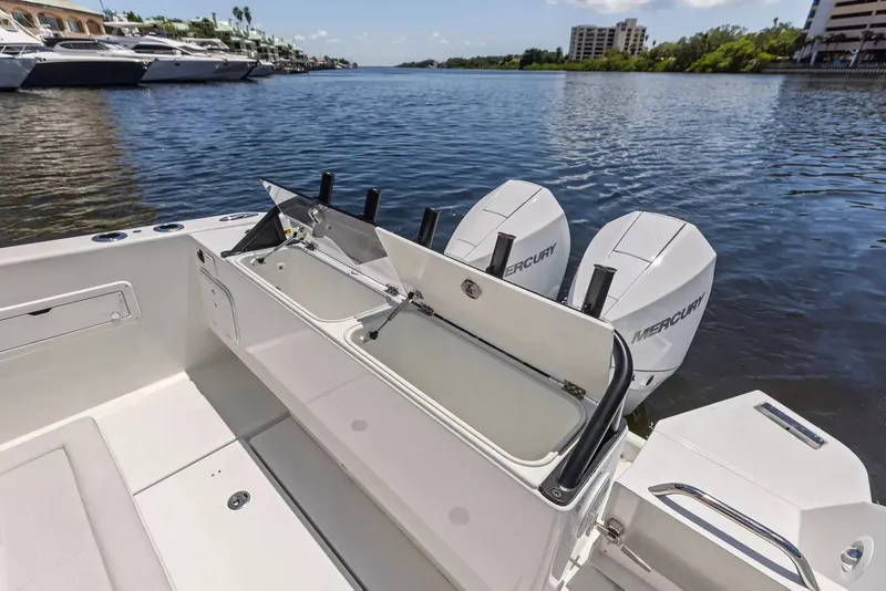 Slide: The Image of The image shows the stern of a Wellcraft 28 Explorer with twin Mercury engines on calm waters. - 9