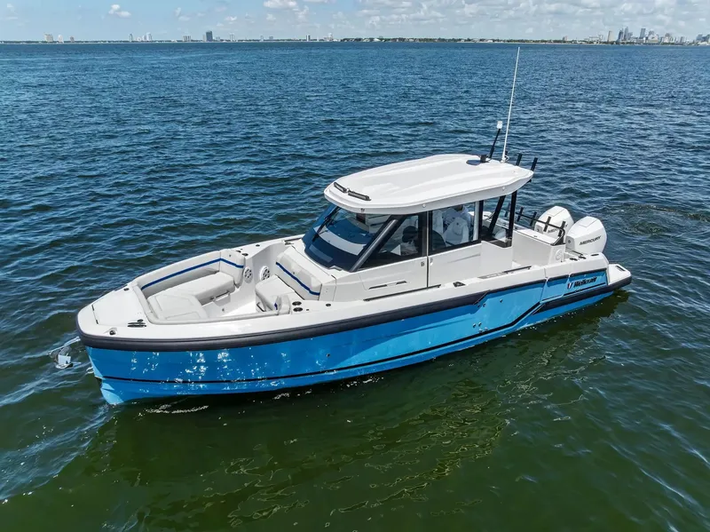 The Image of A 2027 Wellcraft 28 Explorer on calm waters. The boat features a modern design with blue and white paint. - 1