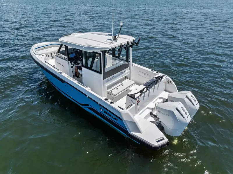Slide: The Image of A 2027 Wellcraft 28 Explorer on calm water. It features a modern design and twin outboard engines. - 2
