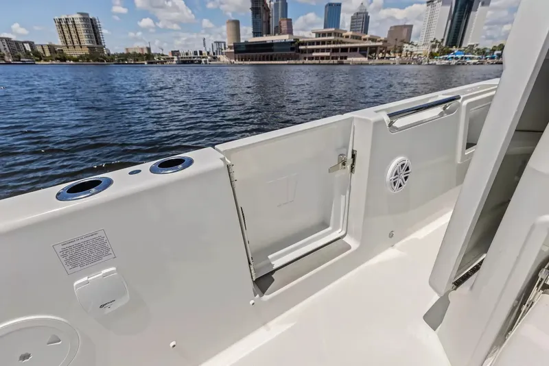Slide: The Image of The image shows the deck of a Wellcraft 28 Explorer boat with a city skyline in the background. - 10