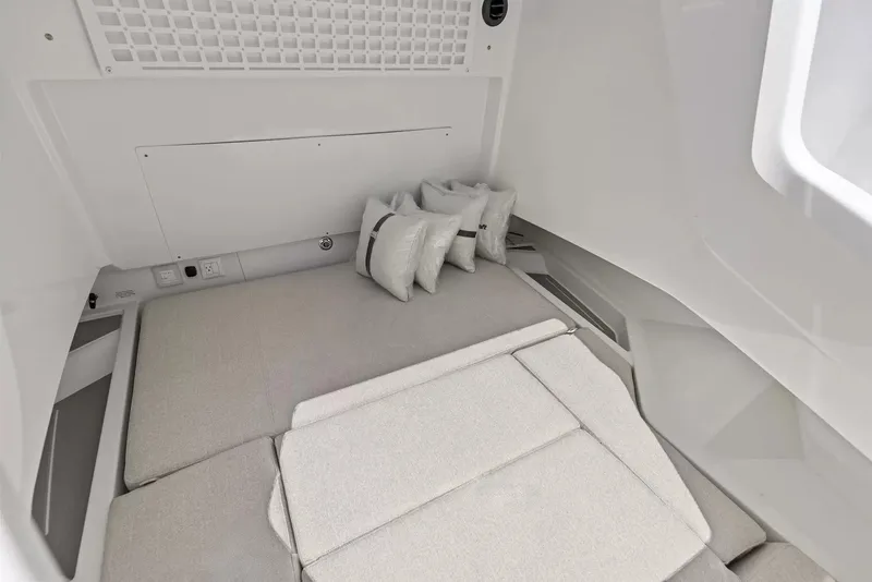 Slide: The Image of Interior of a 2027 Wellcraft 28 Explorer with gray cushions and several pillows. - 25