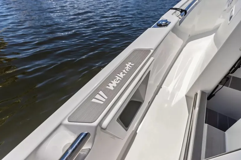 Slide: The Image of Close-up of a Wellcraft 28 Explorer boat by the water, featuring sleek lines and modern design. - 14