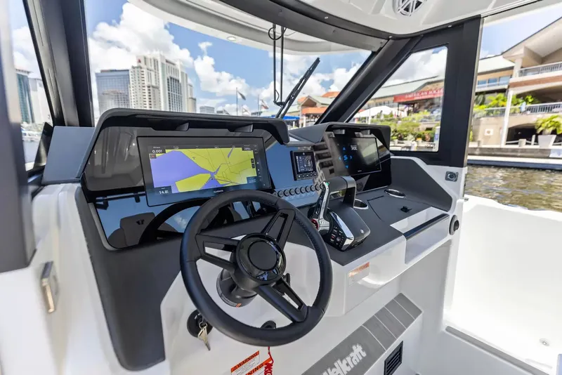 Slide: The Image of The cockpit of the 2027 Wellcraft 28 Explorer features modern navigation systems and controls. - 19